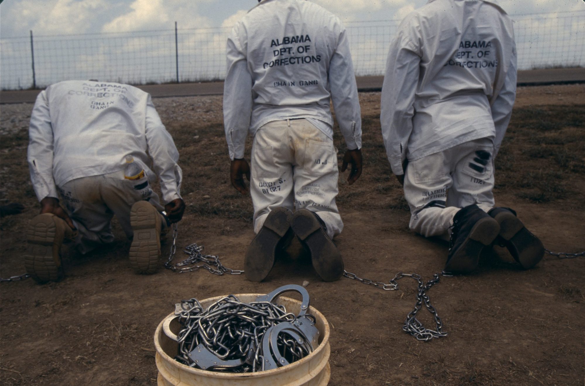 Convicts at the Limestone Correctional facility are placed back onto the chain gang when they leave the prison grounds for their daily labor as road crews in July of 1995 outside of Huntsville, Alabama. Photo by Andrew Lichtenstein/Corbis via Getty Images