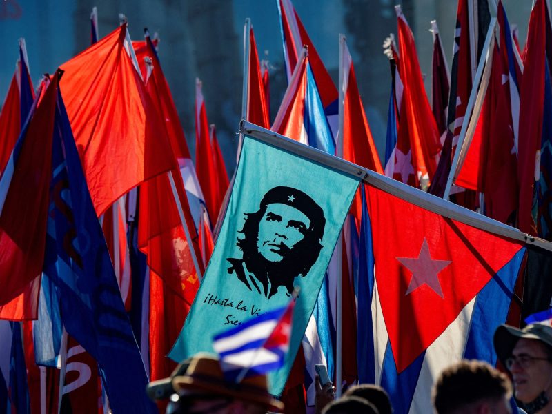 A demonstrator carries a banner with an image of late Argentine-born Marxist revolutionary hero Ernesto "Che" Guevara during the commemoration of May Day (Labour Day) to mark the international day of the workers, at Havana's Revolution Square, on May 1, 2022. Photo by YAMIL LAGE/AFP via Getty Images