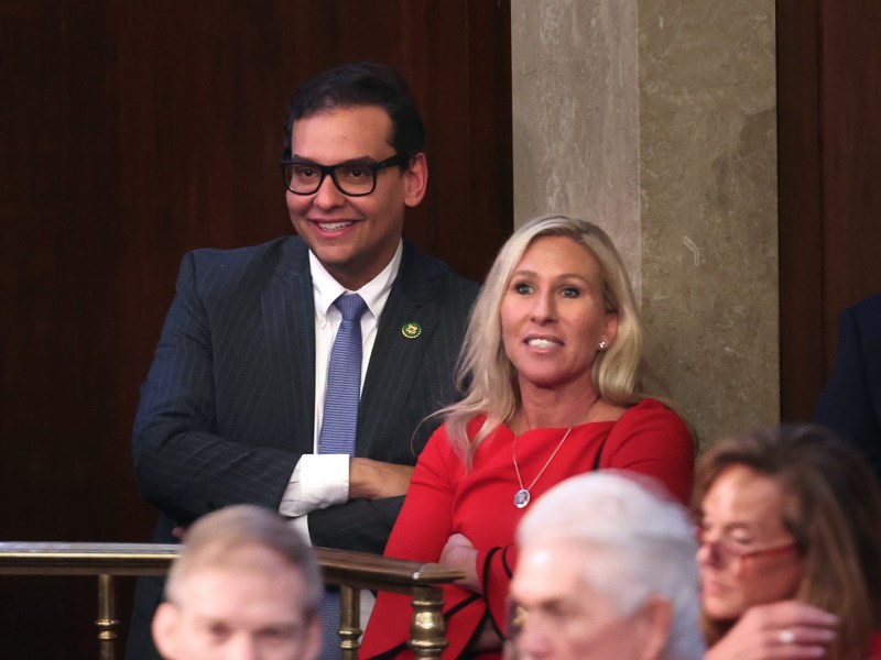 Representative-elect George Santos (R-NY) (L) stands with to Rep.-elect Marjorie Taylor Greene (R-GA) in the House Chamber during the second day of elections for Speaker of the House at the U.S. Capitol Building on Jan. 4, 2023.