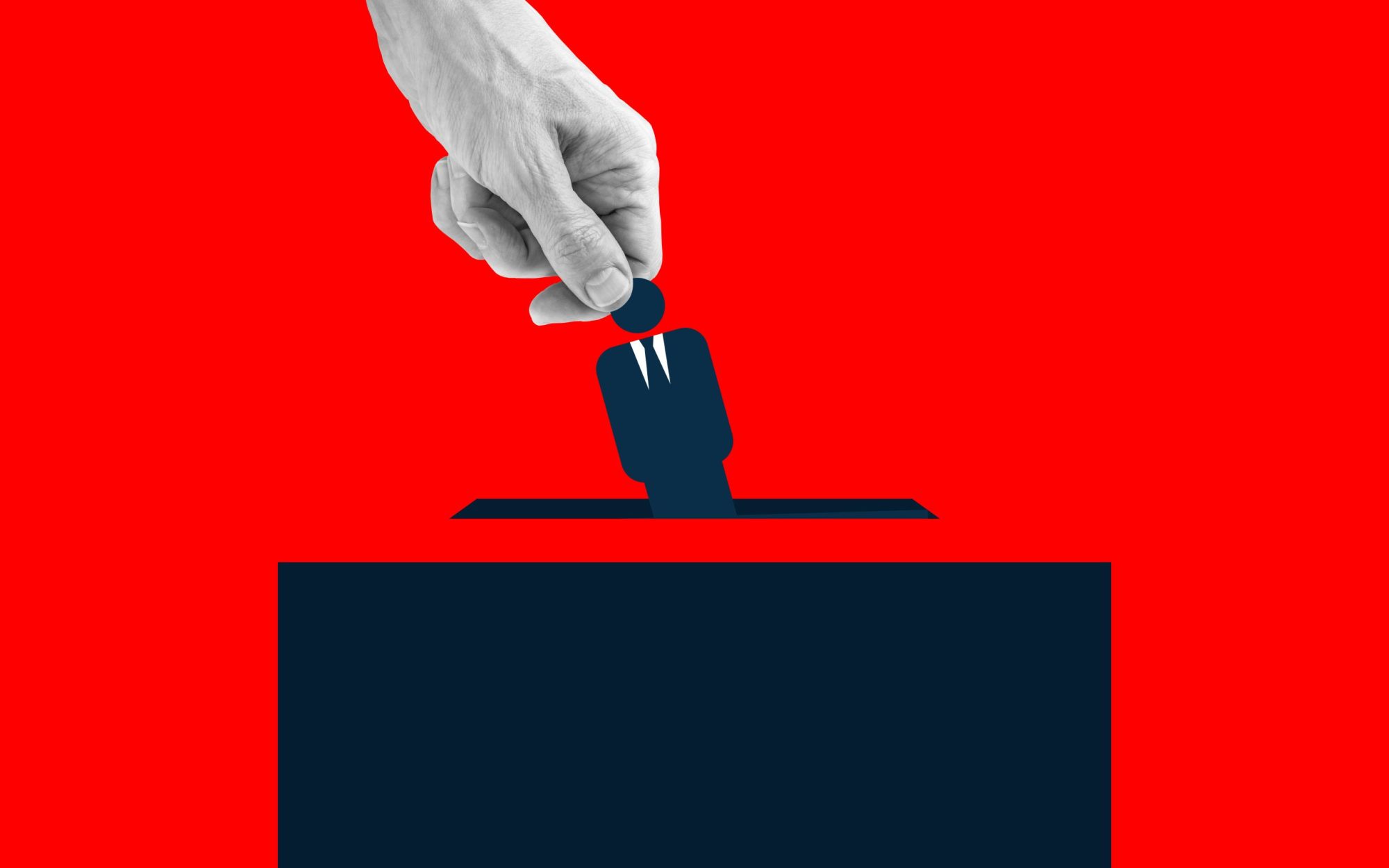 Human hand placing an icon of man wearing suit into the voting box. Via Getty Images