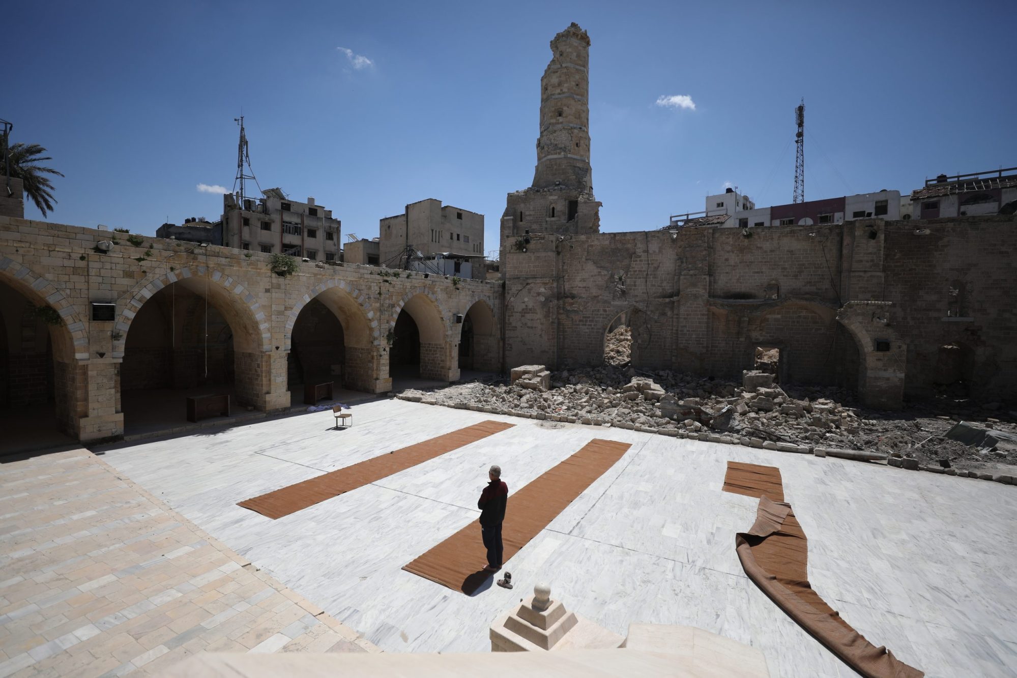 A view of damage as Palestinians gather to read the Holy Qur'an during the last days of Ramadan, in the remaining part of the historic 'Great Omari Mosque,' also known as the 'Great Mosque of Gaza,' following its destruction by Israeli military bombardments in Gaza on April 06, 2024. Photo by Dawoud Abo Alkas/Anadolu via Getty Images