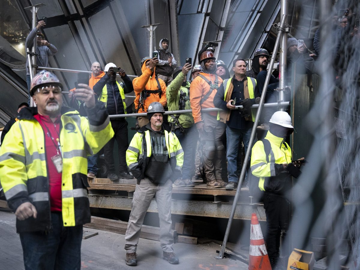 Construction workers watch as former President Donald Trump greets workers and union members at the construction site for the new JPMorgan Chase headquarters in midtown Manhattan before going to Manhattan criminal court in New York, NY on Thursday, April 25, 2024. Photo by Jabin Botsford/The Washington Post via Getty Images