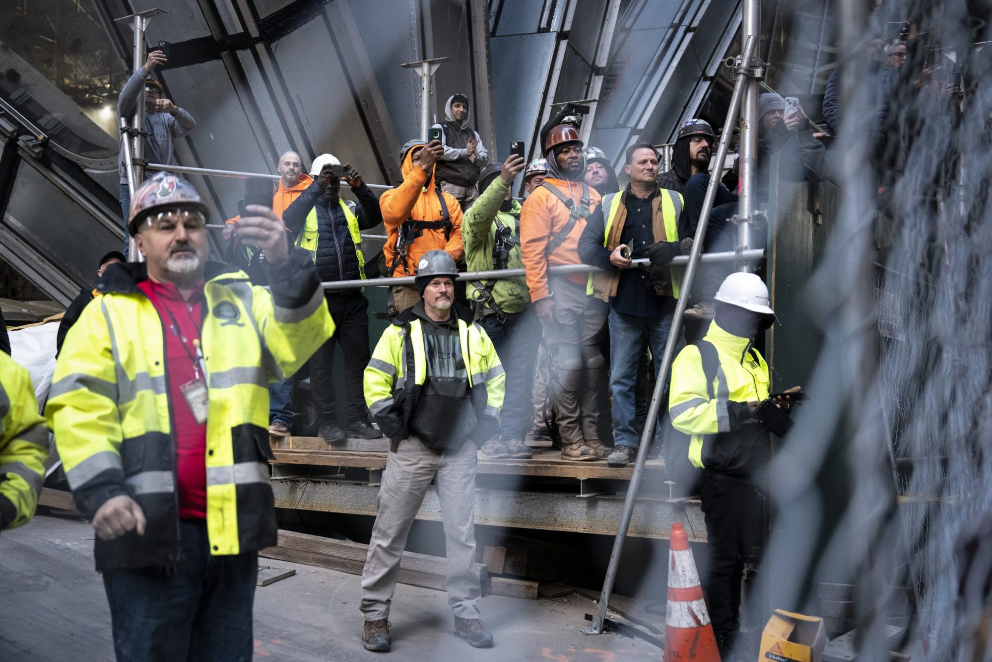 Construction workers watch as former President Donald Trump greets workers and union members at the construction site for the new JPMorgan Chase headquarters in midtown Manhattan before going to Manhattan criminal court in New York, NY on Thursday, April 25, 2024. Photo by Jabin Botsford/The Washington Post via Getty Images