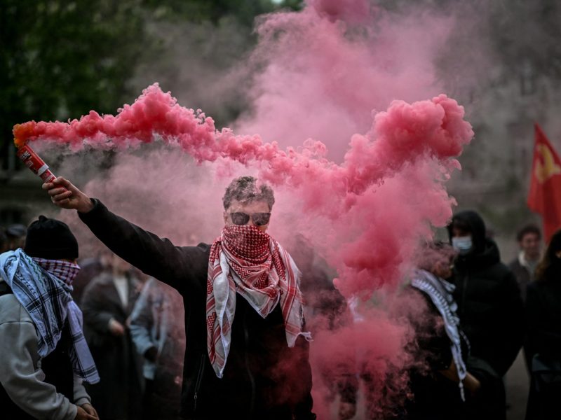 A demonstrator holds up flares during a pro-Palestinian demonstration in the courtyard of the Institute of Political Studies building in Lyon, central Eastern France, on April 30, 2024. Photo by OLIVIER CHASSIGNOLE/AFP via Getty Images