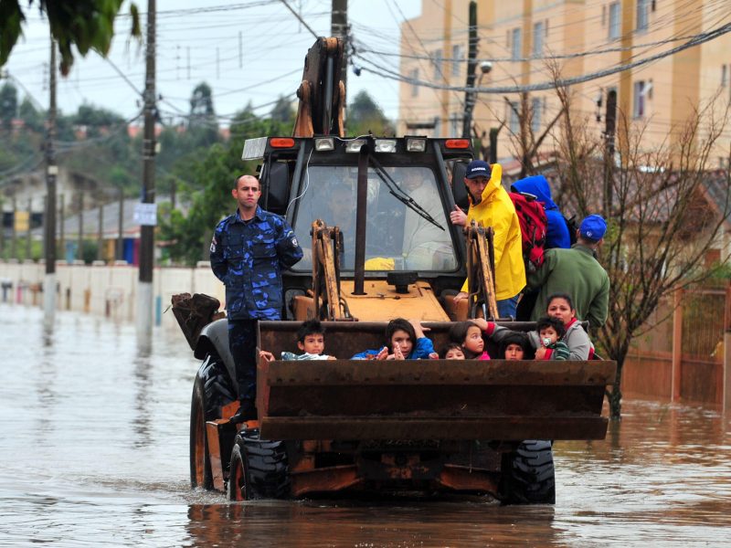 Gravatai, Rio Grande do Sul, Brazil - Jul 14th, 2015: Children are rescued from the flood in a backhoe