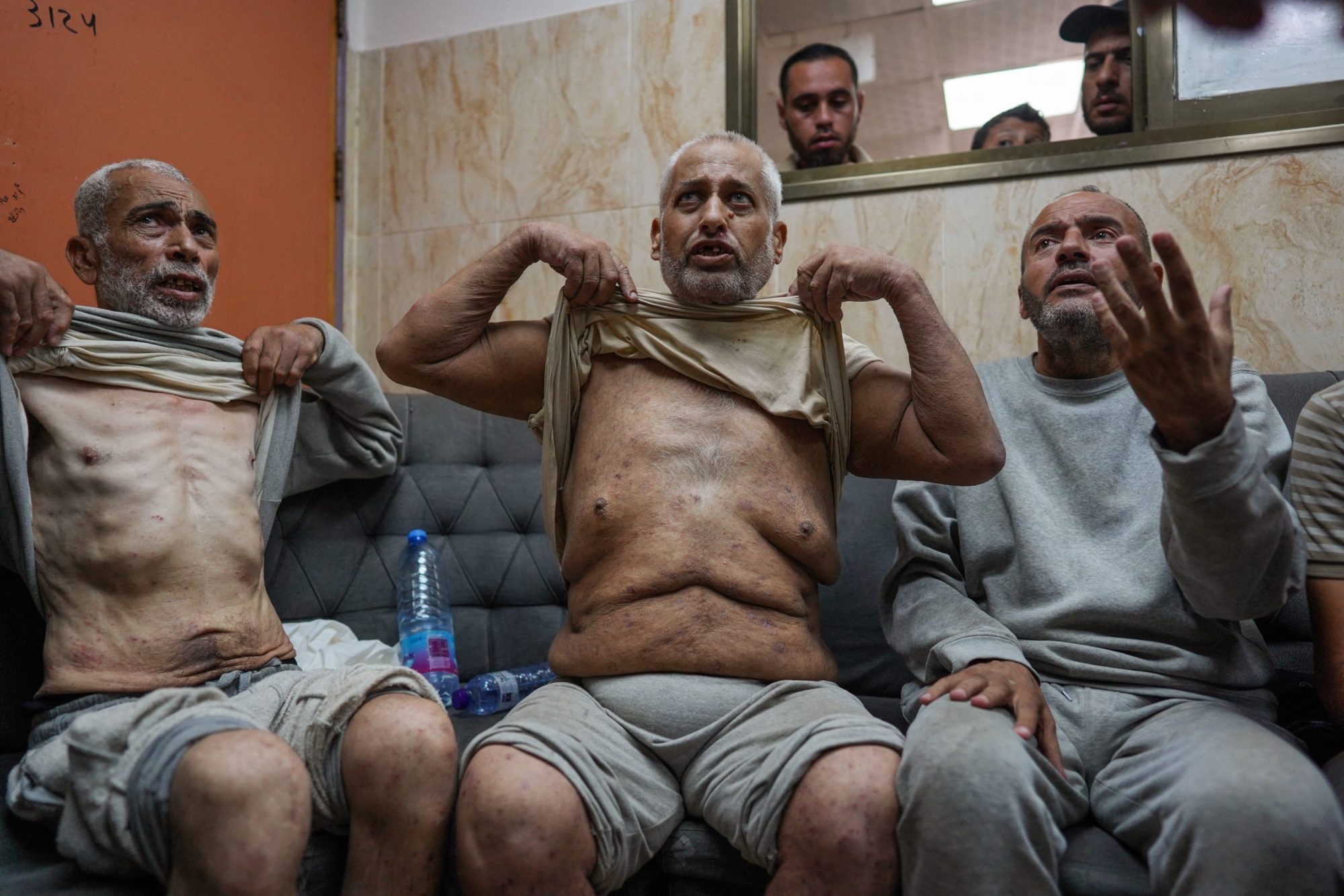 Palestinian men who had been detained by Israeli forces speak to well-wishers and reporters after their release as they arrive for a check-up at the Al-Aqsa Martyrs Hospital in Deir el-Balah in the central Gaza Strip on July 1, 2024 amid the ongoing conflict between Israel and the Palestinian Hamas movement. Photo by BASHAR TALEB/AFP via Getty Images