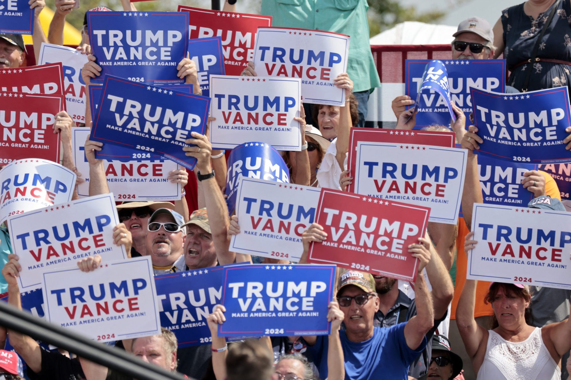 Supporters listen to US Senator and Republican vice presidential candidate J.D. Vance speak about the economy at Majestic Friesians Horse Farms in Big Rapids, Michigan, on August 27, 2024. Photo by JEFF KOWALSKY/AFP via Getty Images