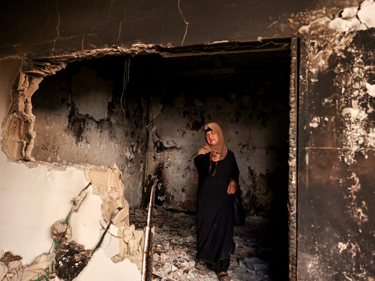 A Palestinian woman points as she stands in a home that was damaged during an Israeli raid the previous day in the Jenin refugee camp in the occupied West Bank on September 26, 2024. Photo by ZAIN JAAFAR/AFP via Getty Images