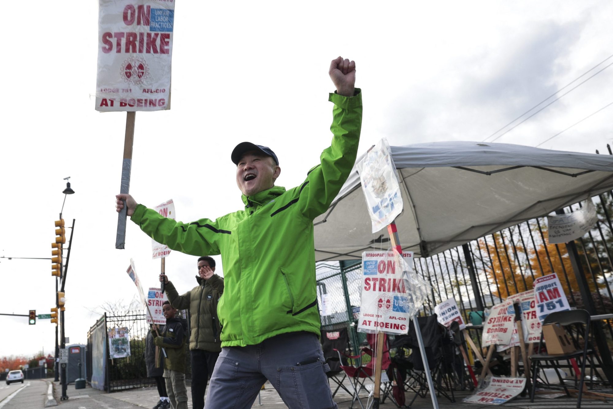 Boeing machinist Charlie Bae reacts to honking cars while picketing outside the Renton Production Facility one day before striking union members will vote on a new contract offer in Renton, Washington on November 3, 2024. Photo by JASON REDMOND/AFP via Getty Images
