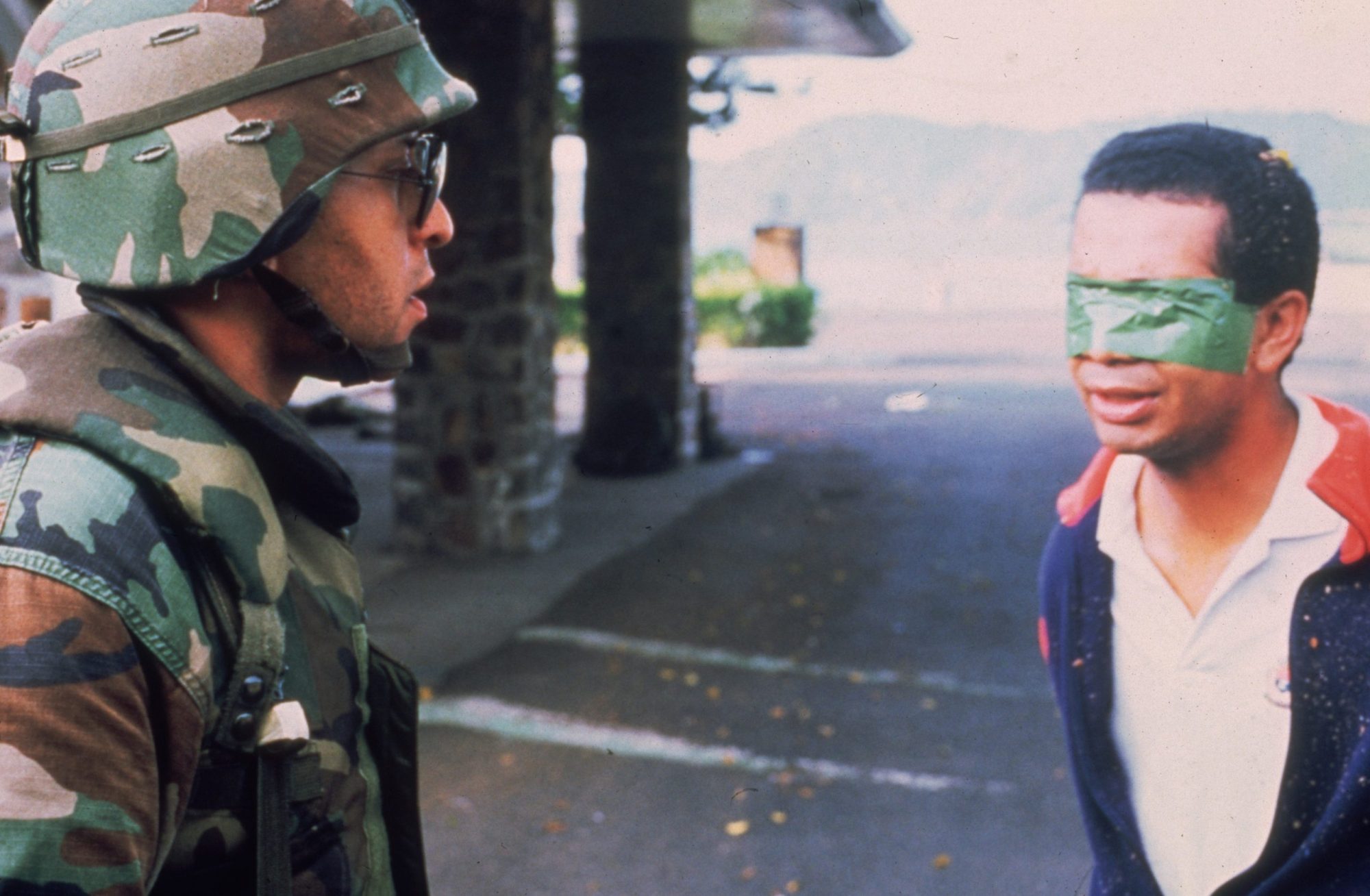 An American soldier stands in the street with a blindfolded Panamanian prisoner during the United States invasion, 'Operation Just Cause,' to oust Panamanian leader General Manuel Noriega. Photo by Consolidated News Pictures/Getty Images