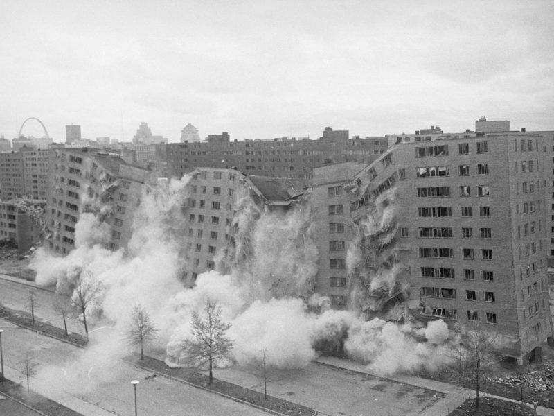 An 11-story building in the massive Pruitt-Igoe public housing complex is demolished by dynamite.