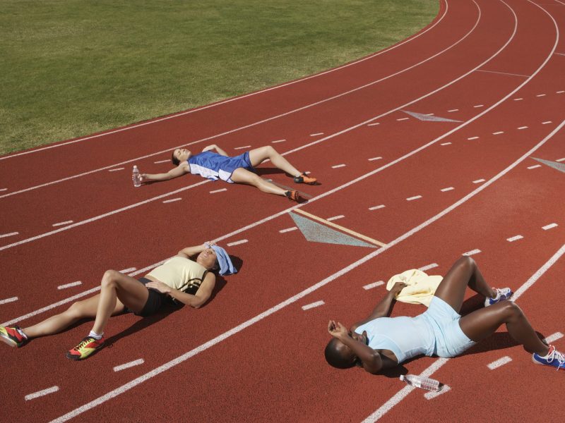 Exhausted runners on track. Photo via Getty Images