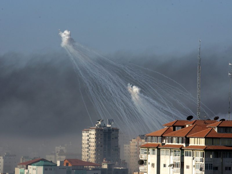 Smoke rises from the United Nation headquarters after an Israeli air force strike as Israeli artillery shells explode over the area on January 15, 2009 in the center of Gaza city, Gaza Strip. Photo by Abid Katib/Getty Images