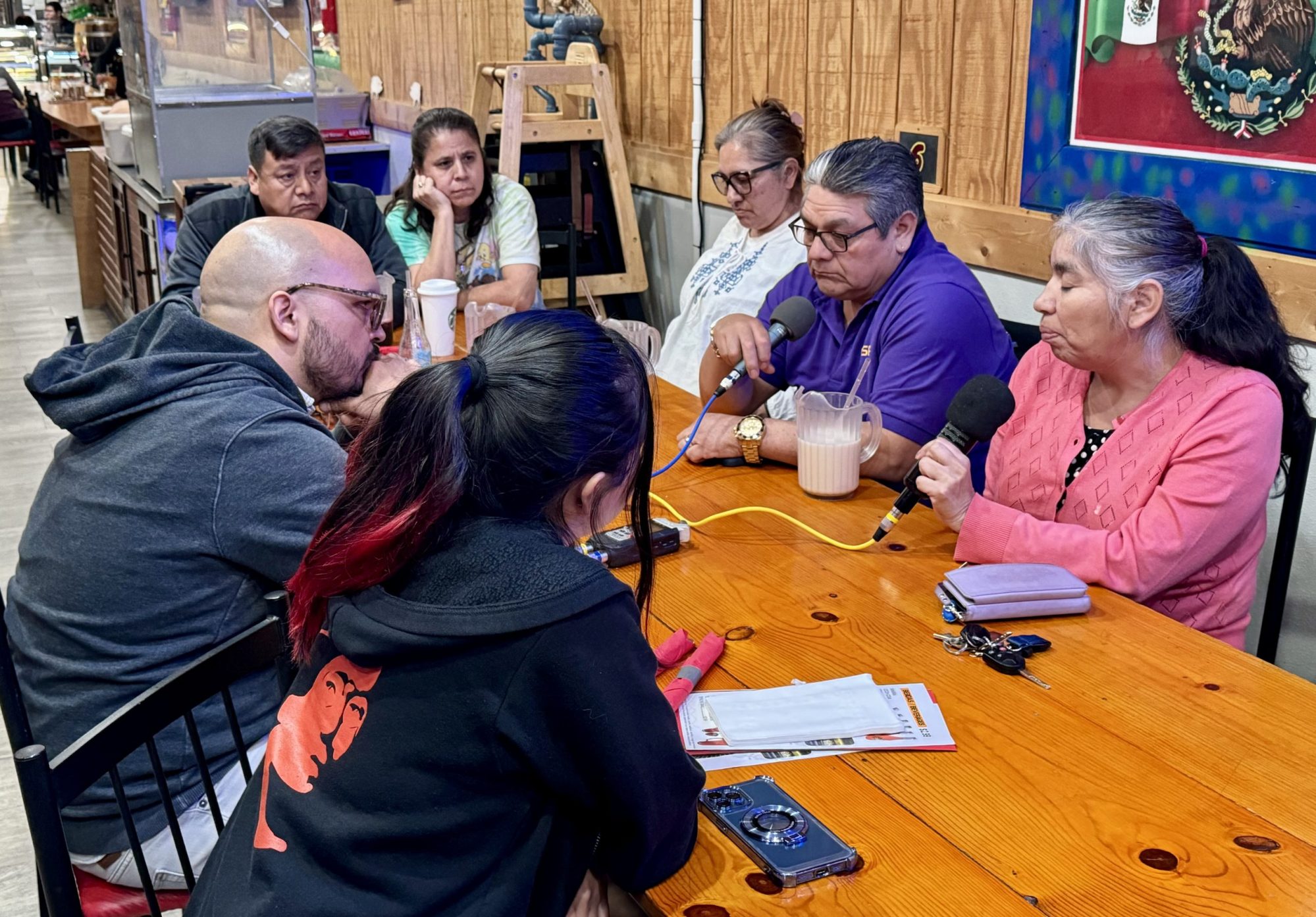 TRNN Editor-in-Chief Maximillian Alvarez (far left) records an in-person podcast with members of the Baltimore Latino/Latine community, including: Victor (top left) and Claudia (top center), co-owners of El Taquito Mexicano restaurant; Lucia Islas (top right) of Comité Latino de Baltimore; Carlos Crespo (right center) of Centro de Apoyo Para la Superación del Inmigrante; Susana Barrios (far right) of Latino Racial Justice Circle; and Norma Martinez (bottom left), a high-school student in Baltimore from Honduras. Photo taken on March 29, 2024 by Ricardo Ortíz of Centro de Apoyo Para la Superación del Inmigrante.