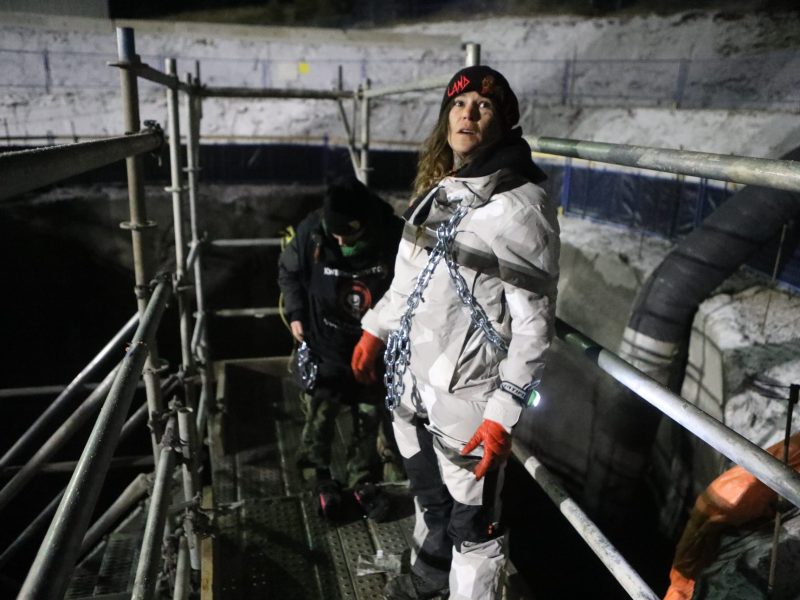 Land defenders Cassie Fox and Khursten Bullock chain themselves to scaffolding at the site of the Trans Mountain Pipeline Expansion (TMX) project's development at Pipsell in Secwepemcul'ecw, on Dec. 10, 2023.