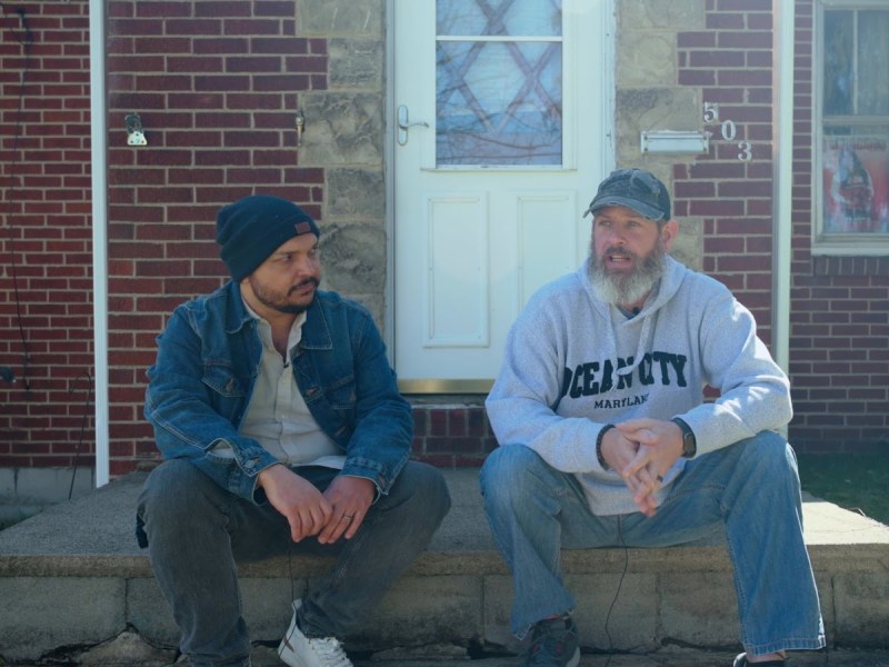 TRNN Editor-in-Chief Maximillian Alvarez (left) sits next to Chris Albright (right) in front of Albright's home in East Palestine, OH. Still image from TRNN documentary report "Trainwreck in 'Trump Country': Partisan Politics Haven't Helped East Palestine, OH" / Mike Balonek