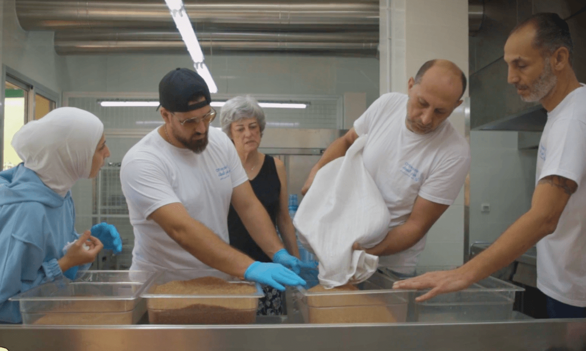 Volunteers at the Beit Aam Community Space in Beirut prepare meals in the community kitchen. Frame taken from video by XXX